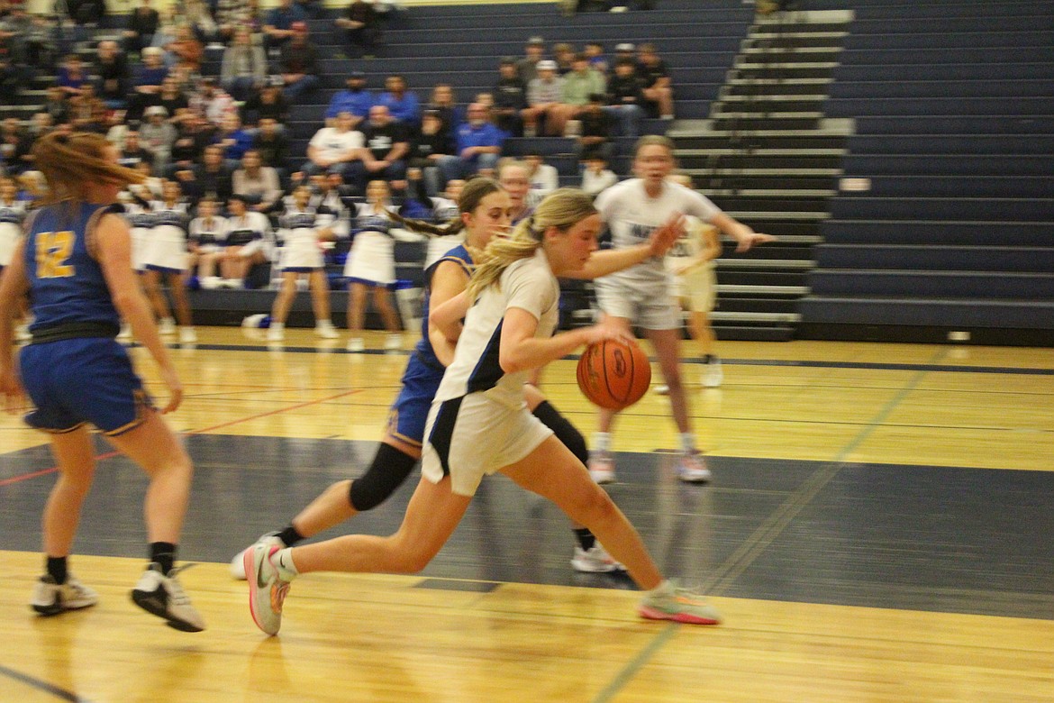 Warden’s Lauryn Madsen, front, heads to the basket in Saturday’s state tournament game