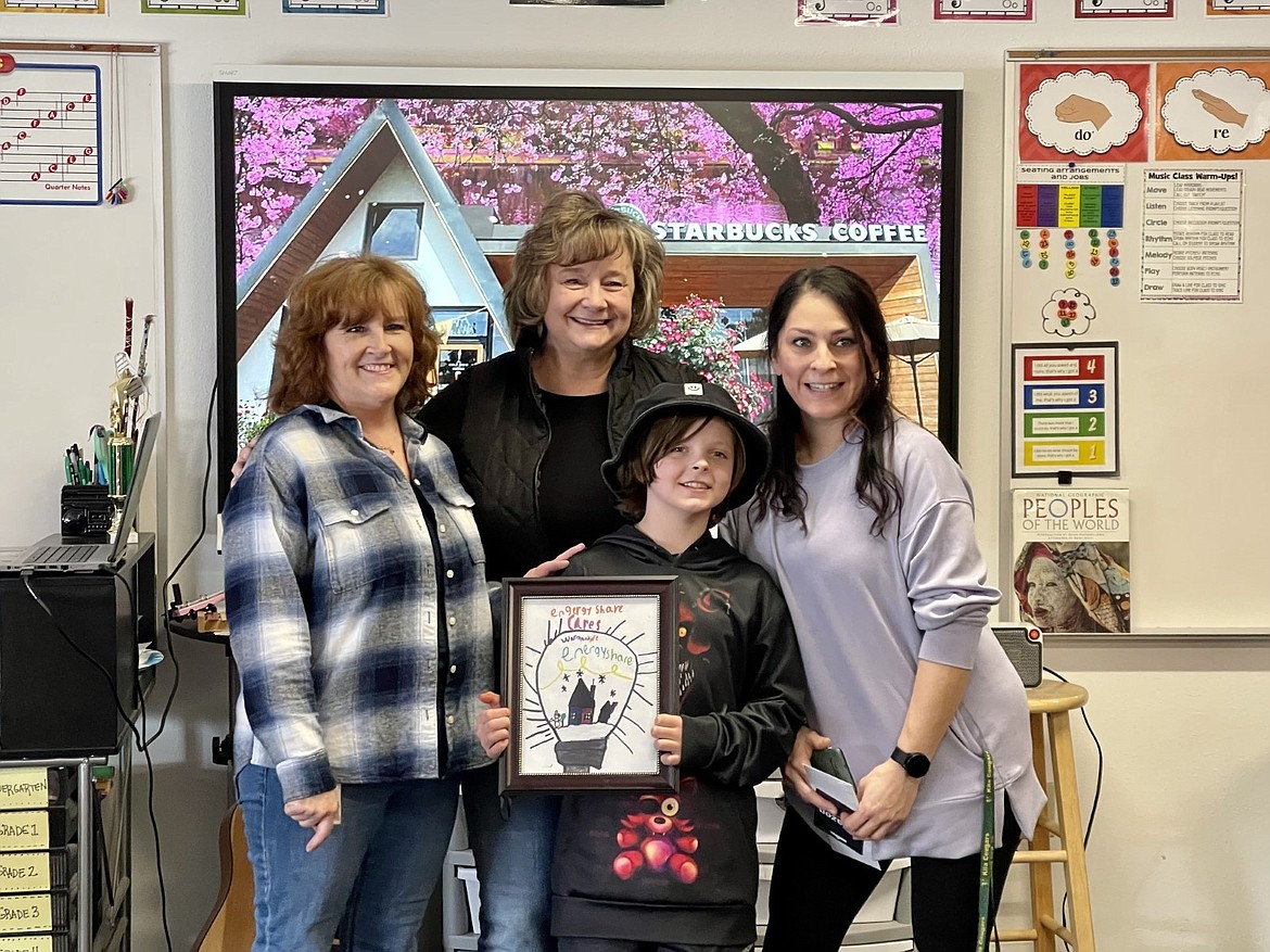 Flathead Electric Cooperative’s Capital Credits and Energy Assistance Administrator Mary Olson, FEC Member Services Manager Teresa Miller honored Kila fourth-grader Kannin Crawford and her teacher Tika Counts after Crawford won third place in Energy Share of Montana’s statewide art contest. (Courtesy photo)