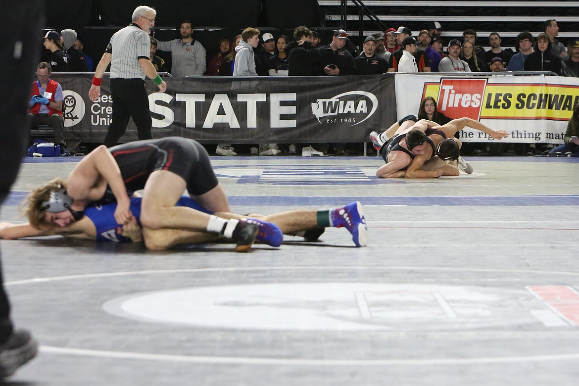 Almira/Coulee-Hartline brothers Tristen Wood, top on the left, and Everett Wood, top on the right, wrestle on side-by-side mats at the 2023 Mat Classic in Tacoma.