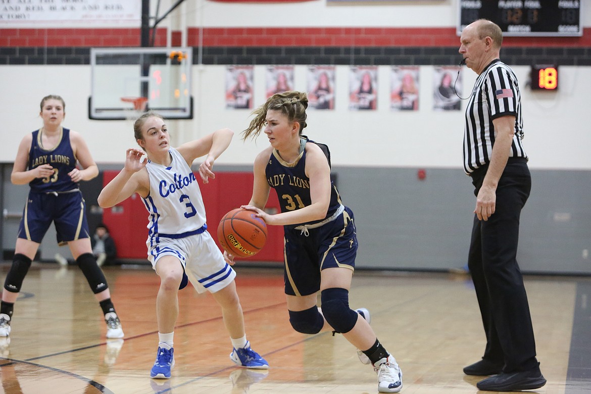 MLCA/CCS senior Makiya Kast (31) runs past a Colton defender in the Lion’s 61-58 loss to the Wildcats in overtime on Saturday.