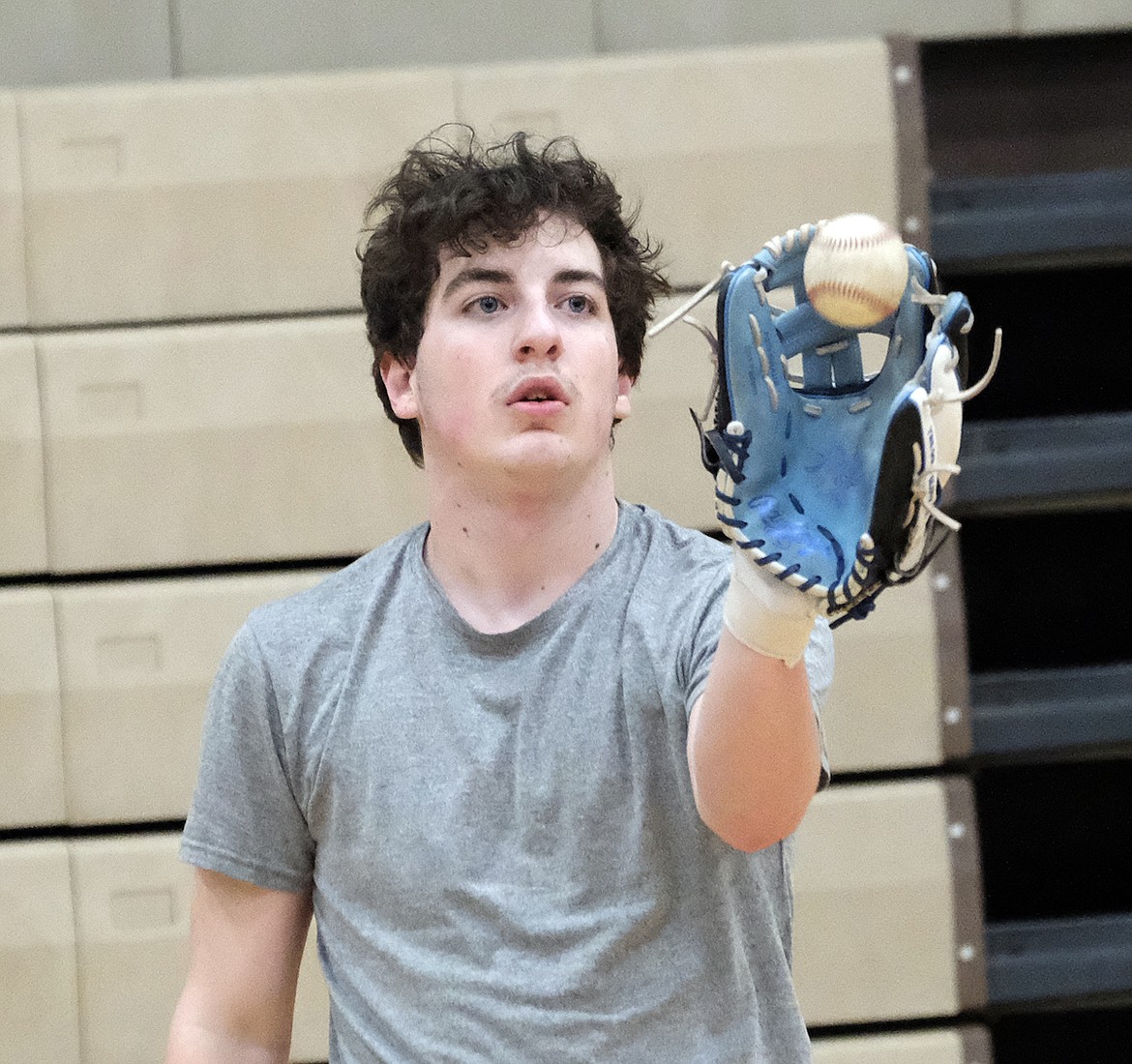 Libby Loggers American Legion baseball player Chase Rayome watches the ball into his glove in the first practice on Feb. 23 at the Libby High School gym. (Paul Sievers/The Western News)