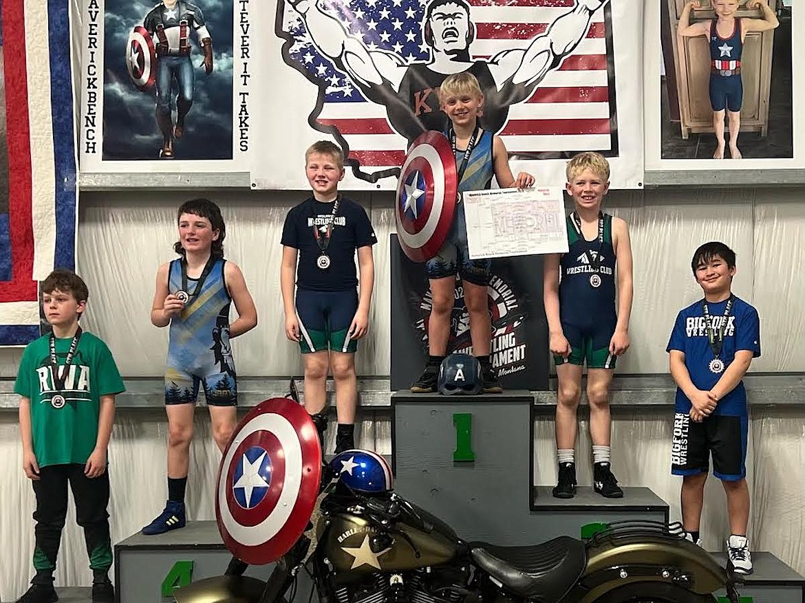 Libby Wrestling Club's Acton Farmer stands atop the medal stand Saturday at the Maverick Bench Memorial Tournament in Kalispell. Farmer claimed first place at 85 pounds in the novice group. Joining Farmer is teammate Teegan Gillespie, who was fourth.(Photo courtesy Libby Wrestling Club)