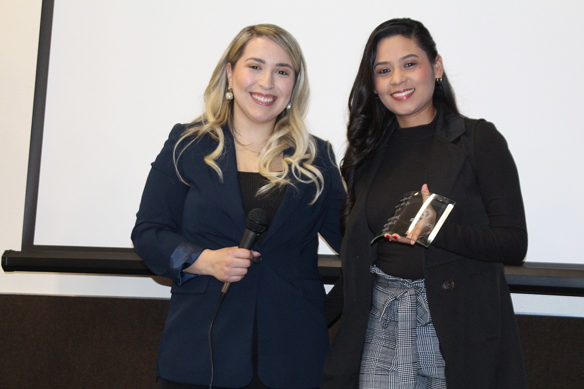 Janette Zuniga-Gomez, right, receives the K-5 Teacher of the Year award from 2022 Othello Chamber president Thalia Lemus.