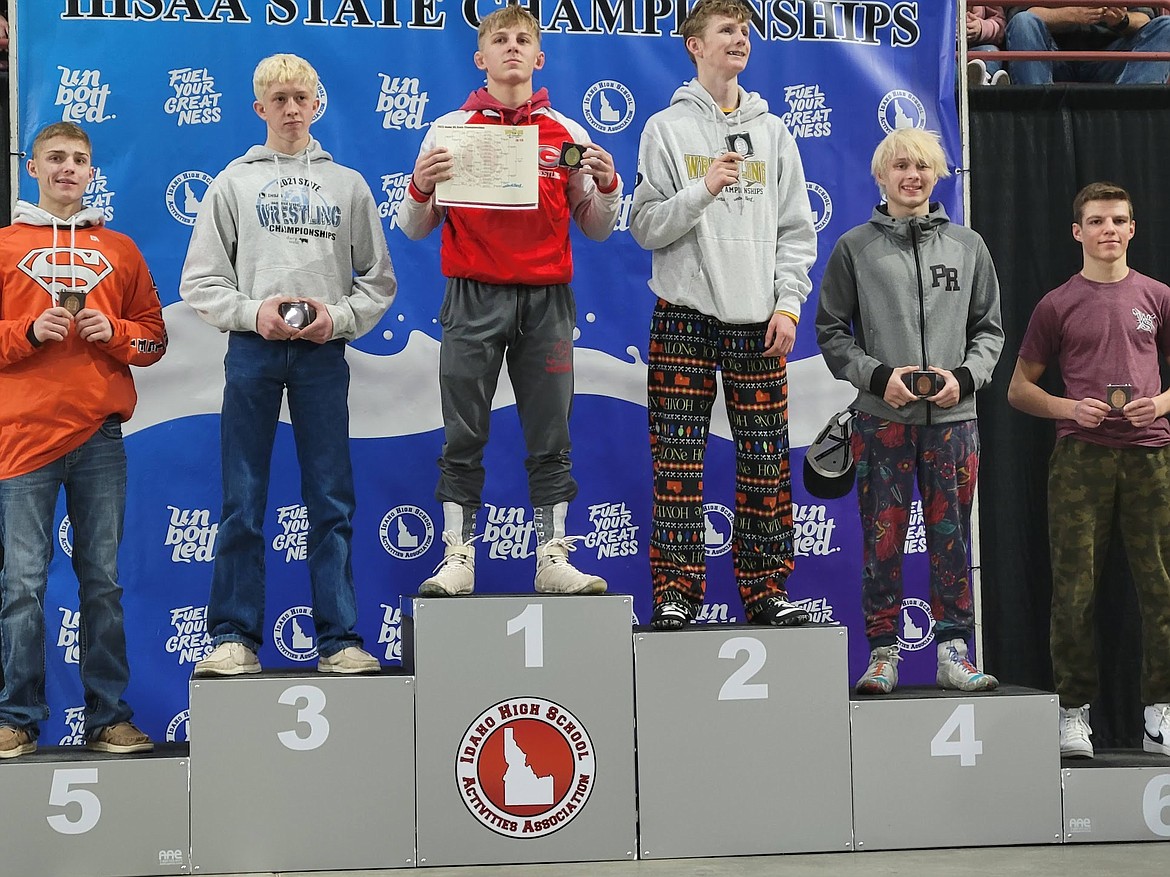 Hayden Sorbel (113) of Priest River poses on the podium while being awarded for his fourth place finish at the State Championship meet.