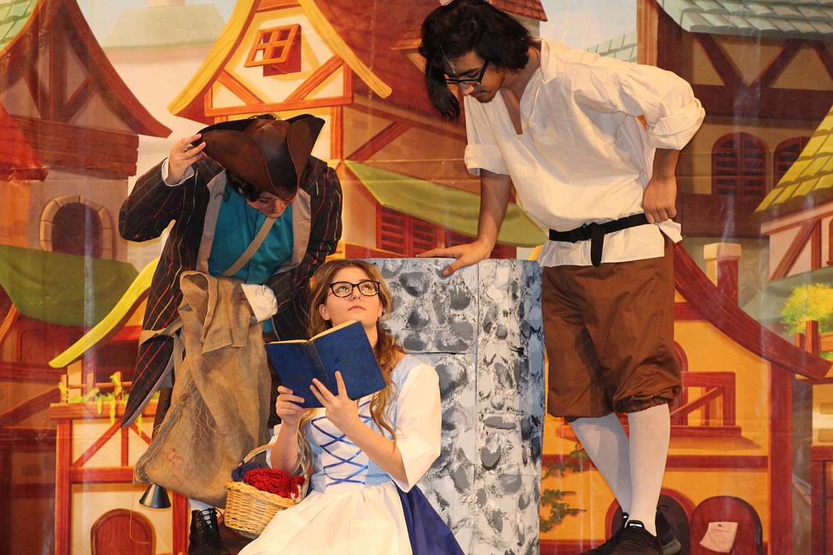 Belle (Hailey Beegle), front, is interrupted by her unwanted suitor Gaston (Alijsha Quintanilla) right, and his sidekick Lefou (Allie Manley), left, in the Quincy High School production of “Beauty and the Beast,” opening Friday.