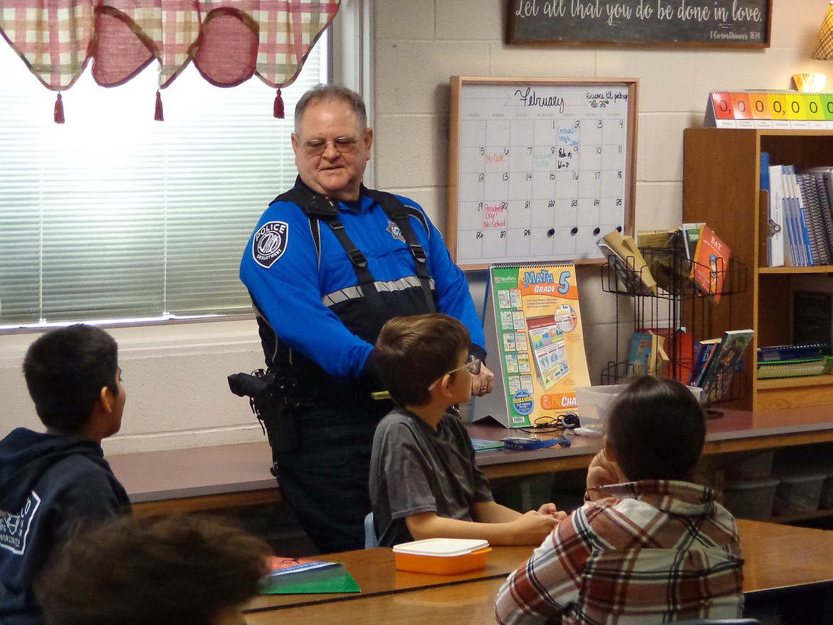 Warden Police Chief Rick Martin gets ready to read to third graders at Warden Elementary School as part of Read Across America Week.