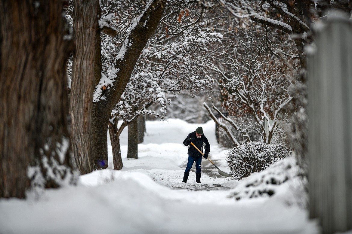 A resident shovels snow along Fifth Street East at Fifth Avenue East in Kalispell on Tuesday, Feb. 28. (Casey Kreider/Daily Inter Lake)