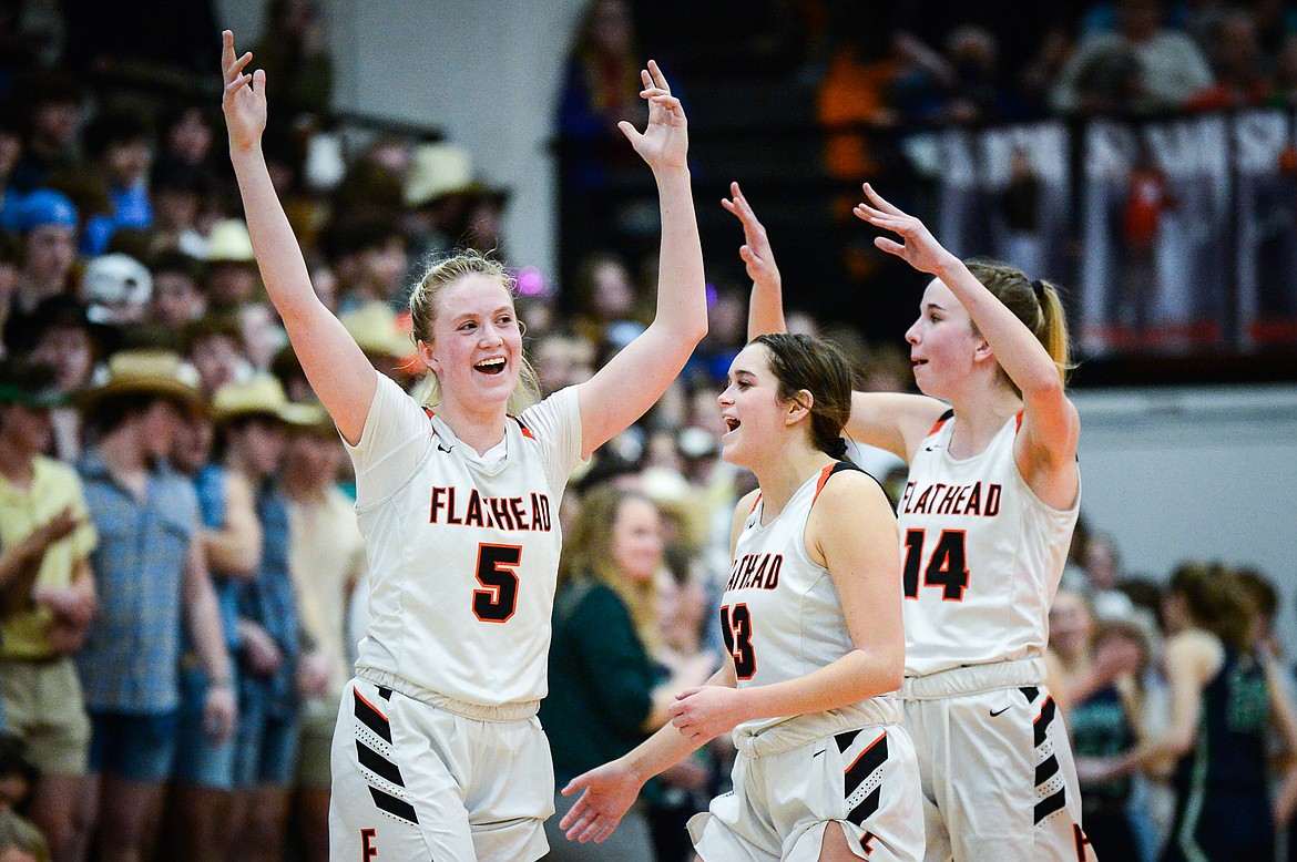 Flathead's Maddy Moy (5), Avery Chouinard (13) and Kennedy Moore (14) celebrate after the Bravettes' 41-34 win over Glacier at Flathead High School on Thursday, Feb. 16. (Casey Kreider/Daily Inter Lake)