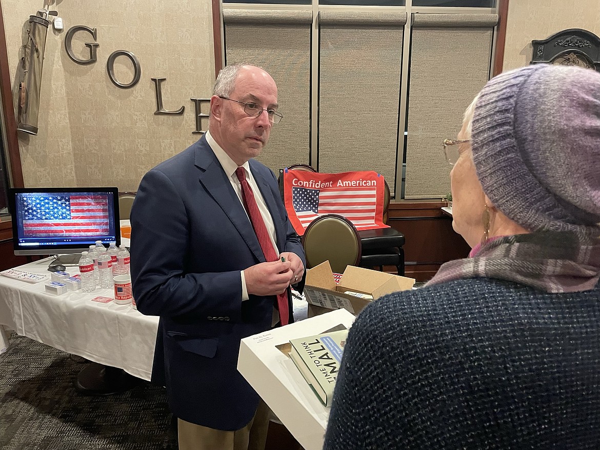 Todd Myers, director of environmental policy for the Washington Policy Center, speaks with a county party member after the GOP’s annual Lincoln Day dinner on Saturday.