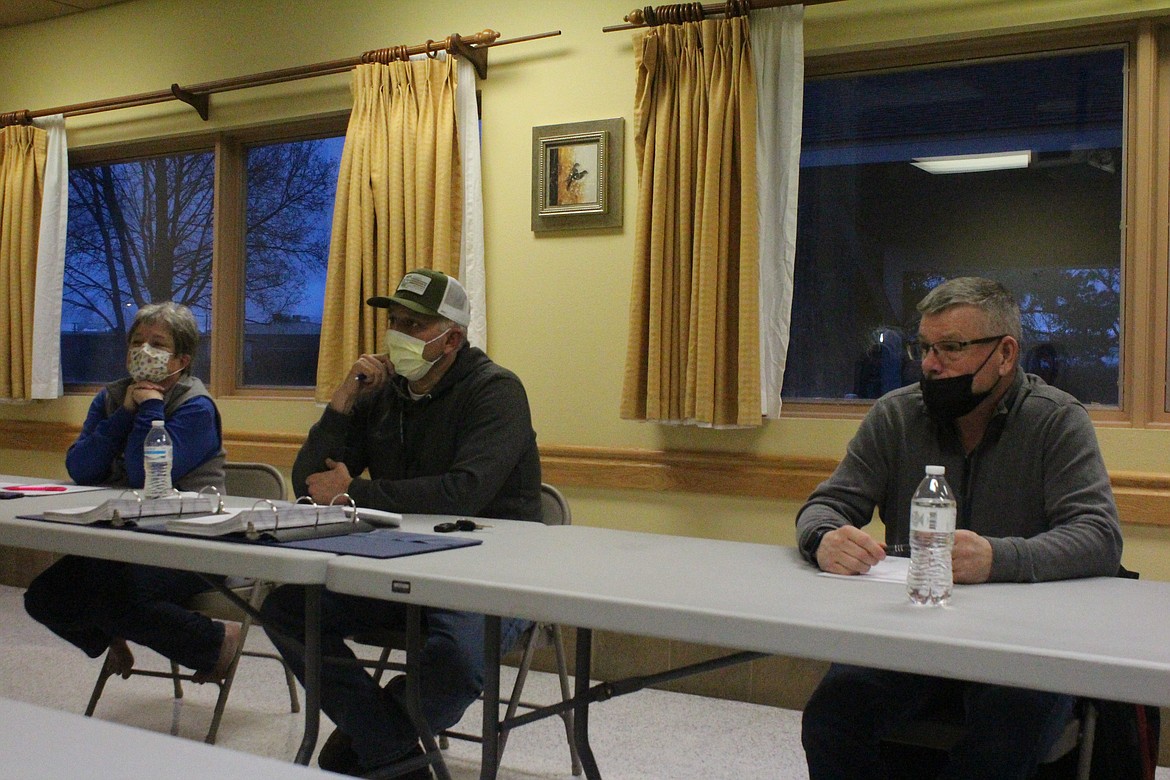 Quincy Valley Medical Center board members, from left, Sherri Kooy, Anthony Gonzalez and Randy Zolman listen to a presentation on the new QVMC. Board members are masked per ongoing COVID-19 pandemic rules that require masks in many medical facilities.