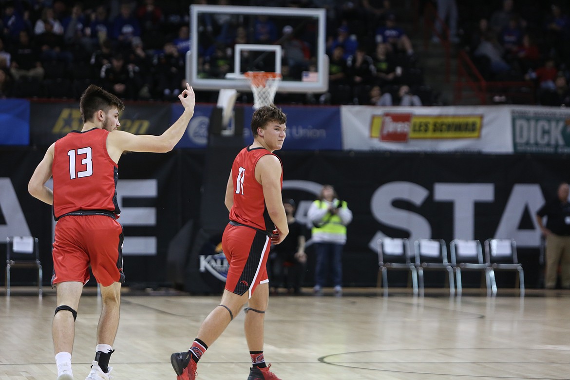 LRS seniors Nick Labes, left, and Hunter Dinkins, right, celebrate after Dinkins made a three-pointer in the third quarter of the Broncos’ 61-46 win over Adna in the 2B Boys State Basketball Tournament.