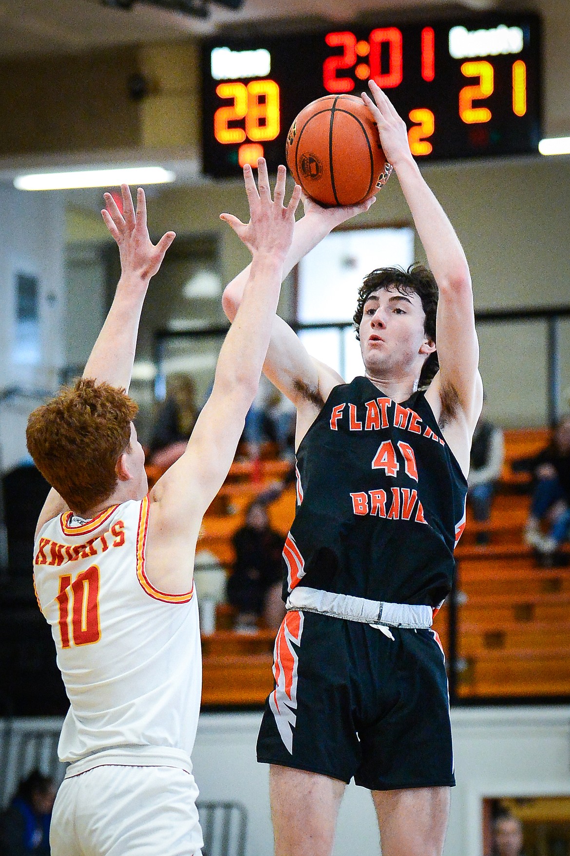 Flathead's Noah Cummings (40) looks to shoot in the second quarter guarded by Missoula Hellgate's Connor Dick (10) during the Western AA Divisional Tournament at Flathead High School on Thursday, March 2. (Casey Kreider/Daily Inter Lake)