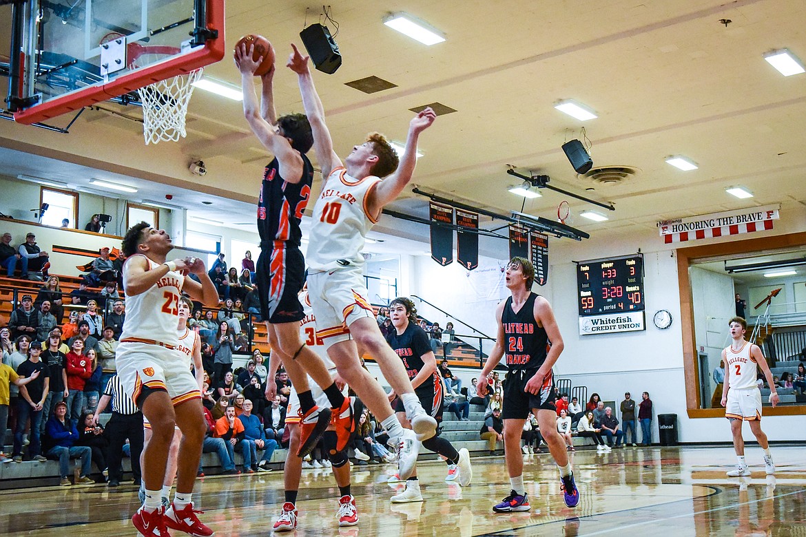 Flathead's Brody Thornsberry (23) drives to the basket past Missoula Hellgate's Connor Dick (10) in the fourth quarter during the Western AA Divisional Tournament at Flathead High School on Thursday, March 2. (Casey Kreider/Daily Inter Lake)