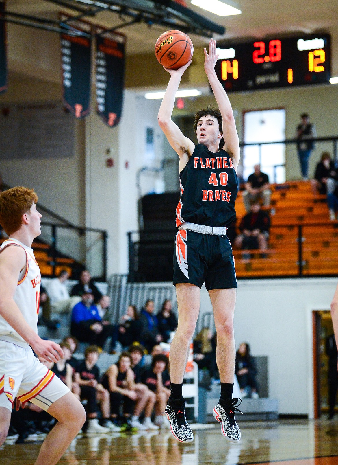 Flathead's Noah Cummings (40) knocks down a jumper at the end of the first quarter against Missoula Hellgate during the Western AA Divisional Tournament at Flathead High School on Thursday, March 2. (Casey Kreider/Daily Inter Lake)