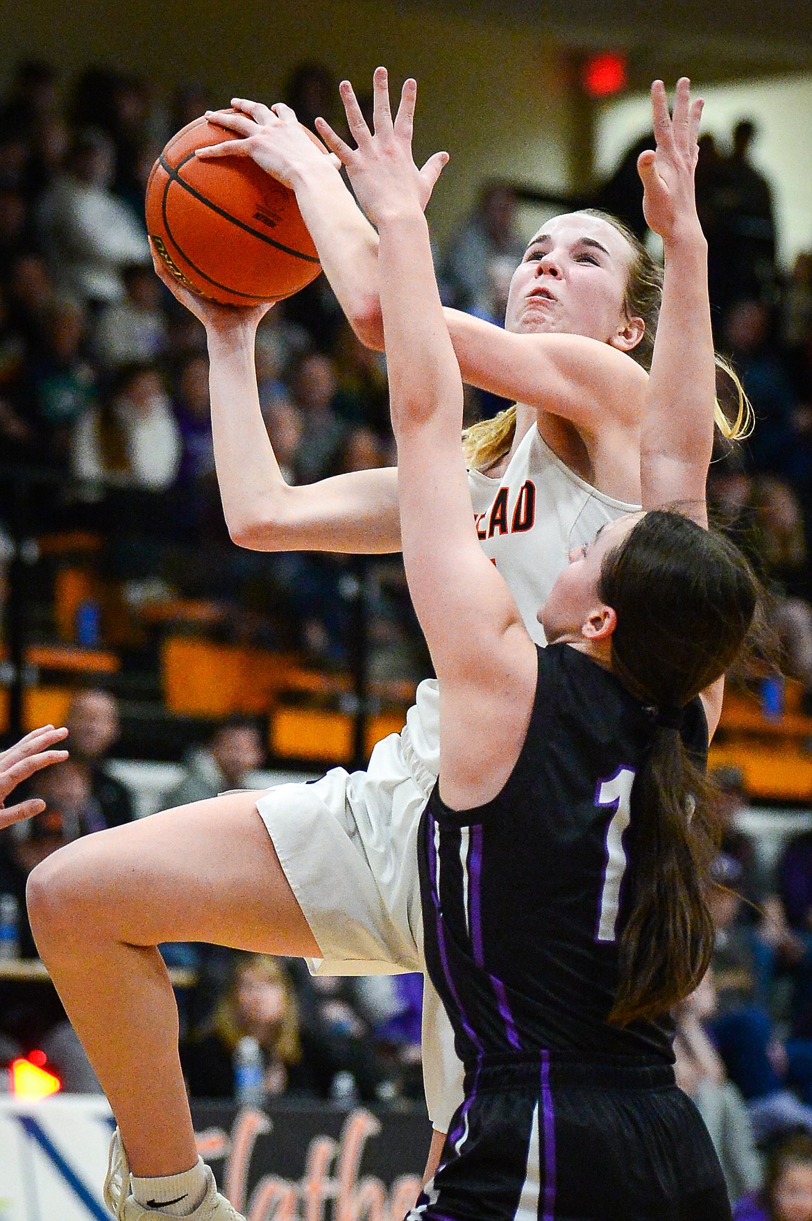 Flathead's Kennedy Moore (14) drives to the basket guarded by Butte's Brityn Stewart (13) in the fourth quarter during the Western AA Divisional Tournament at Flathead High School on Thursday, March 2. (Casey Kreider/Daily Inter Lake)