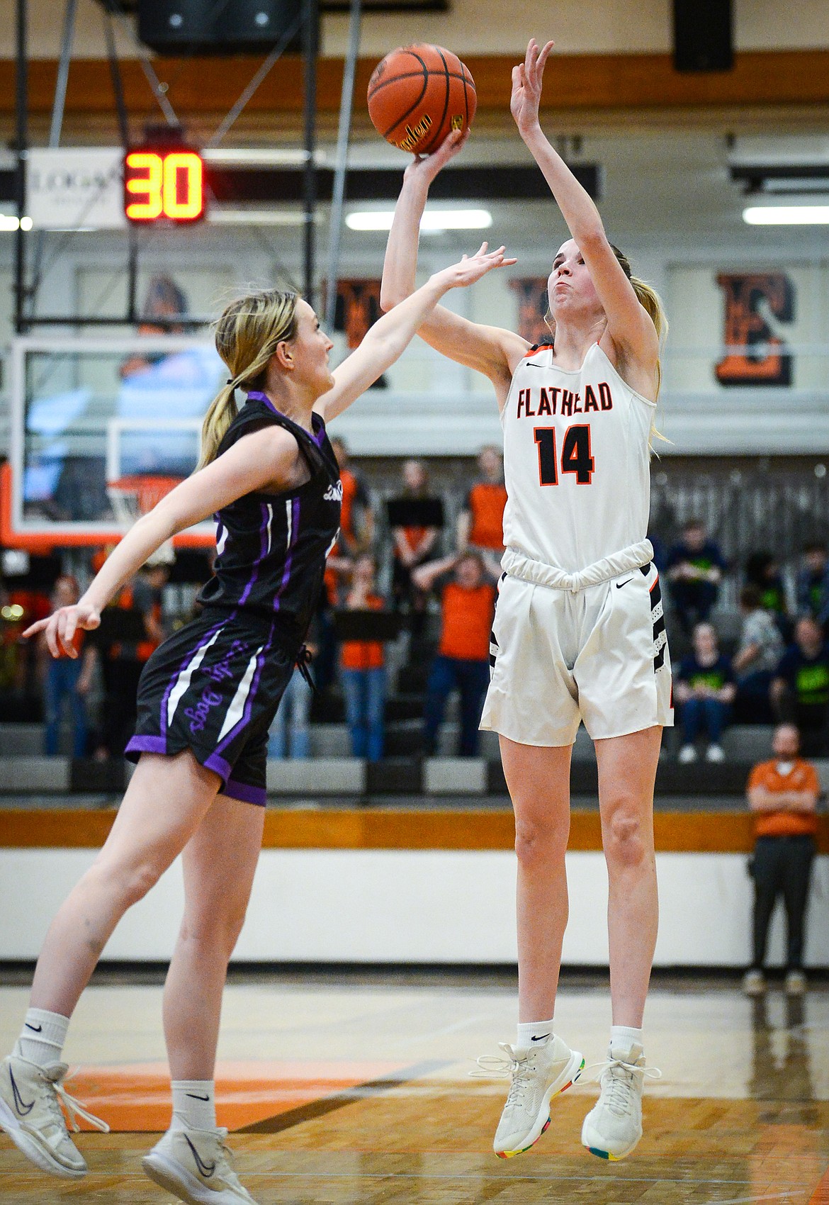 Flathead's Kennedy Moore (14) knocks down a three in the second quarter against Butte during the Western AA Divisional Tournament at Flathead High School on Thursday, March 2. (Casey Kreider/Daily Inter Lake)