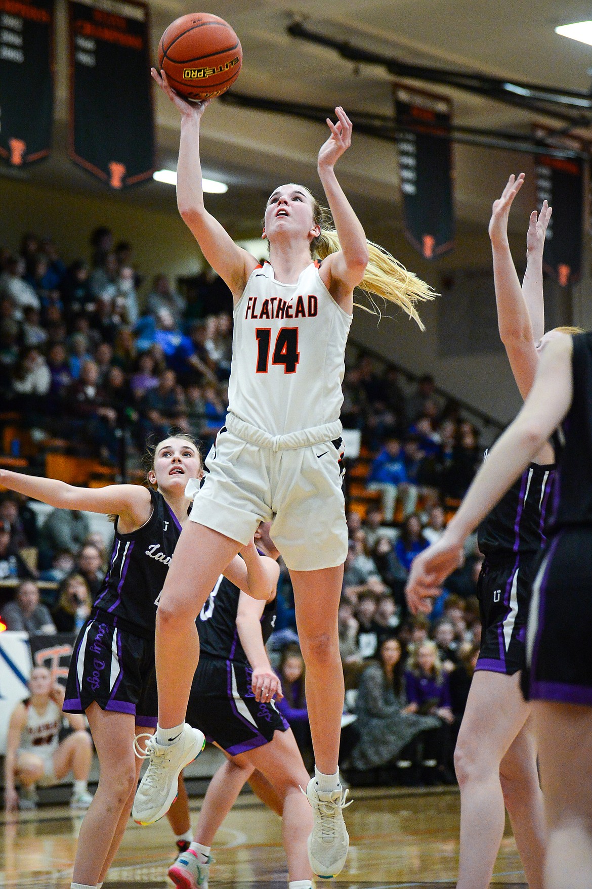 Flathead's Kennedy Moore (14) drives to the basket in the fourth quarter against Butte during the Western AA Divisional Tournament at Flathead High School on Thursday, March 2. (Casey Kreider/Daily Inter Lake)