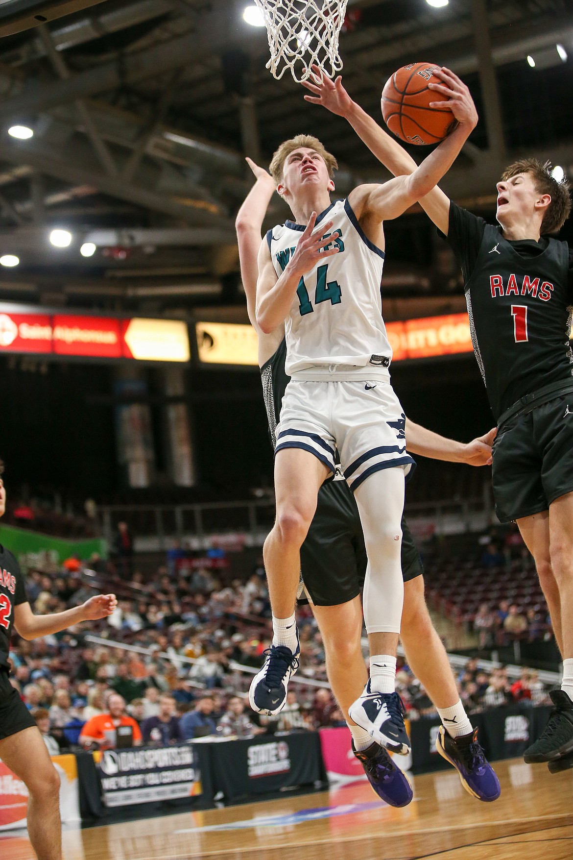 JASON DUCHOW PHOTOGRAPHY
Kolton Mitchell (14) of Lake City soars for a layup try as Colt Durham (1) of Highland defends Thursday night in a state 5A first-round tournament game at the Ford Idaho Center in Nampa.