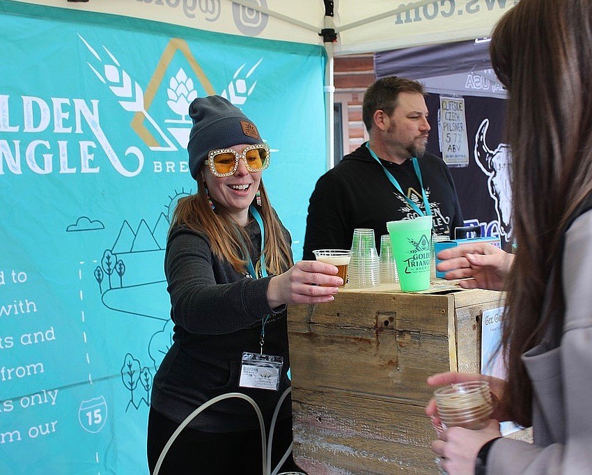 Golden Triangle Brewing co-owner Stacia Fuzesy serves up a cold beer at Bigfork Brewfest in 2022. (Taylor Inman/Daily Inter Lake FILE)