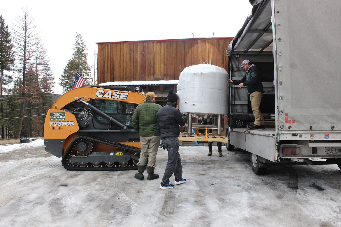 Golden Triangle Brewing Co. owner Brandon Roberts helps unload a tank for the brewery's new location in Bigfork. (Taylor Inman/Daily Inter Lake)