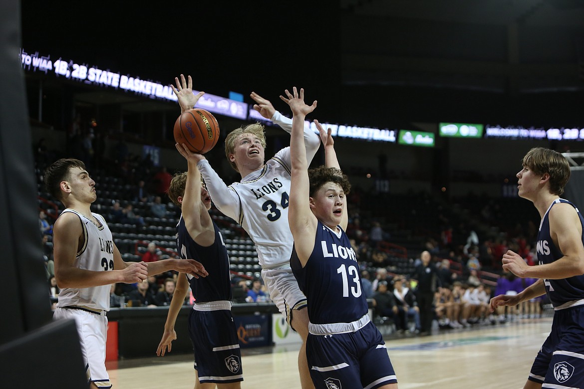 MLCA/CCS junior Jonah Robertson (34) drives to the rim late in the fourth quarter against Sound Christian on Wednesday night. Robertson led all scorers with 21 points.