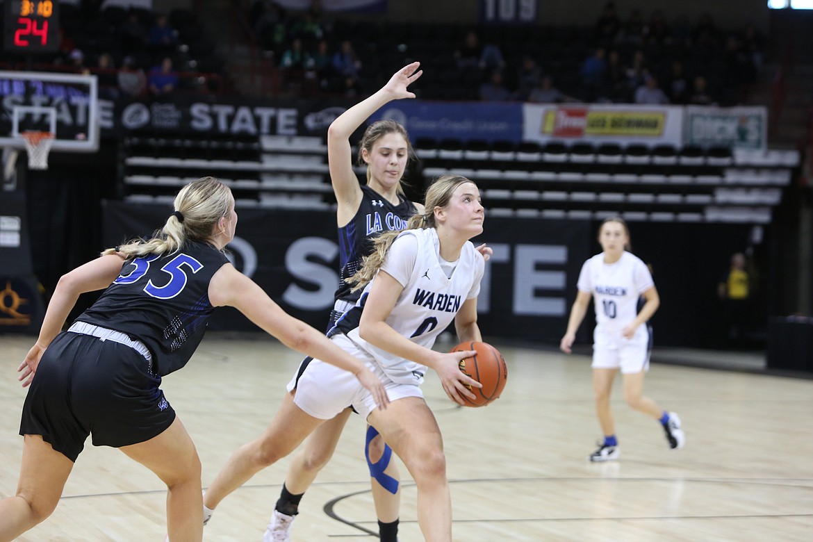 Warden junior Lauryn Madsen, in white, led the Cougars with 23 points and seven steals in Thursday’s 58-43 win over La Conner.