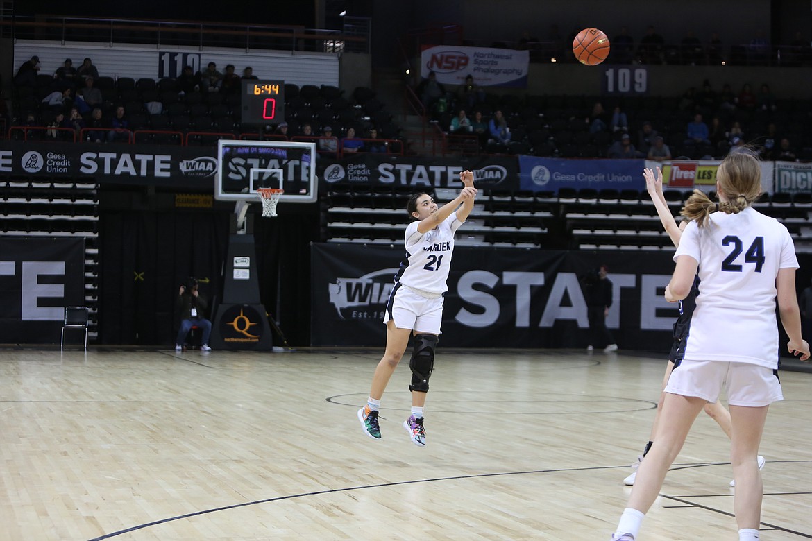 Warden senior JLynn Rios (21) shoots the ball as the shot clock expires in the fourth quarter against La Conner. Rios finished with 12 points, all of which came off of three-pointers.