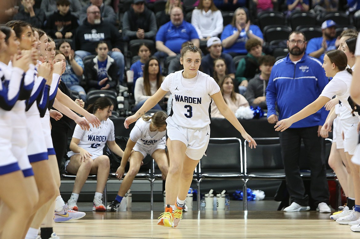 Warden senior Quinn Erdmann runs out of the tunnel of Cougar players during player introductions before playing La Conner, which Warden defeated 58-43 late Thursday to advance in the 2B girls state semifinals. For more complete coverage, check out Monday edition of the Columbia Basin Herald.