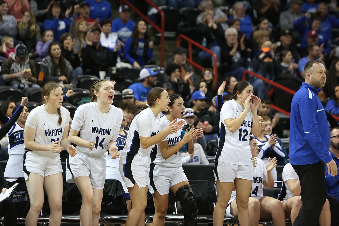 The Cougar bench cheers after a made three-pointer by senior JLynn Rios in the third quarter.