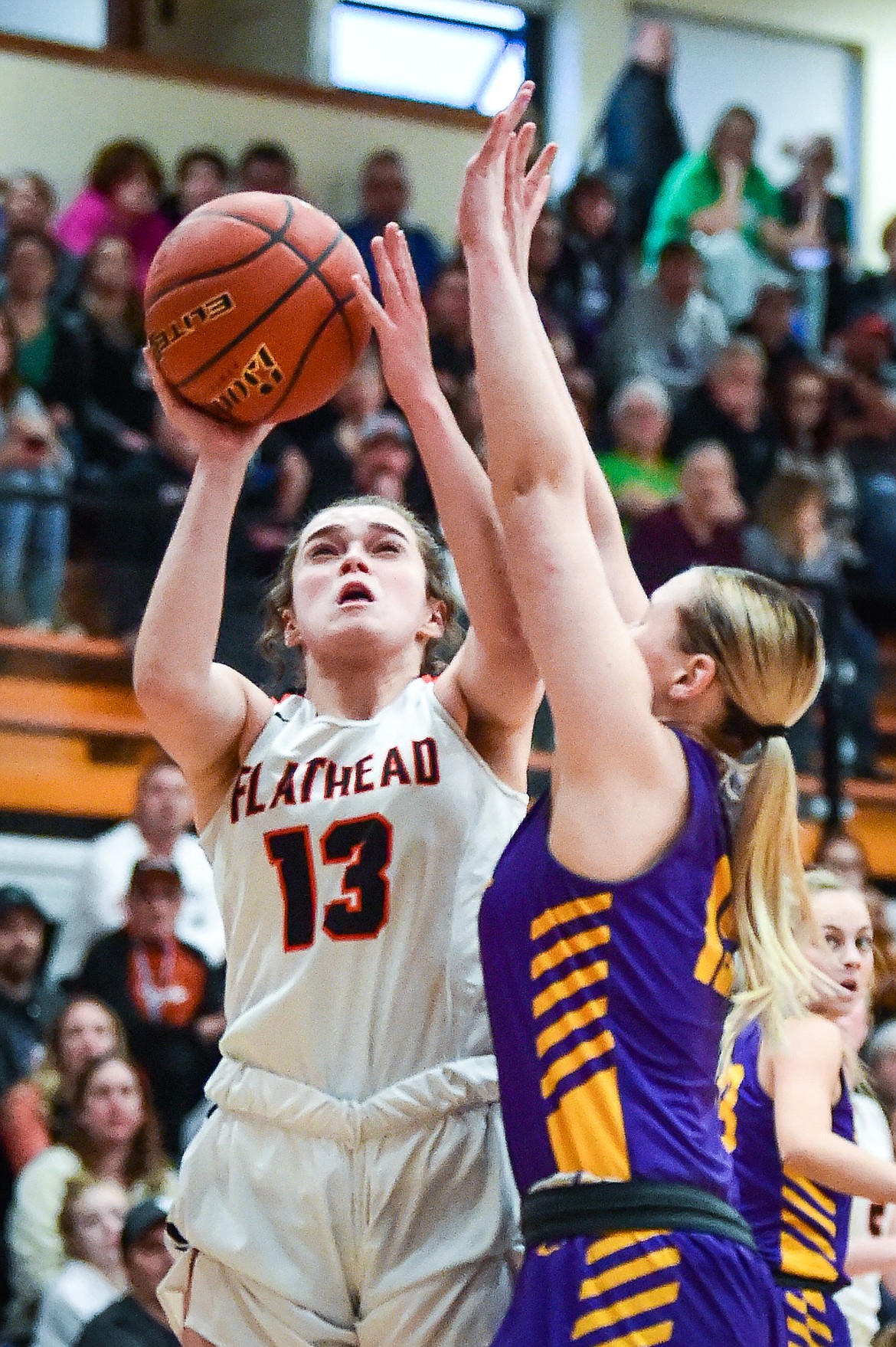 Flathead's Avery Chouinard (13) shoots in the first half against Missoula Sentinel's Monroe Mastro (15) in the Western AA Divisional Tournament semifinal at Flathead High School on Friday, March 3. (Casey Kreider/Daily Inter Lake)