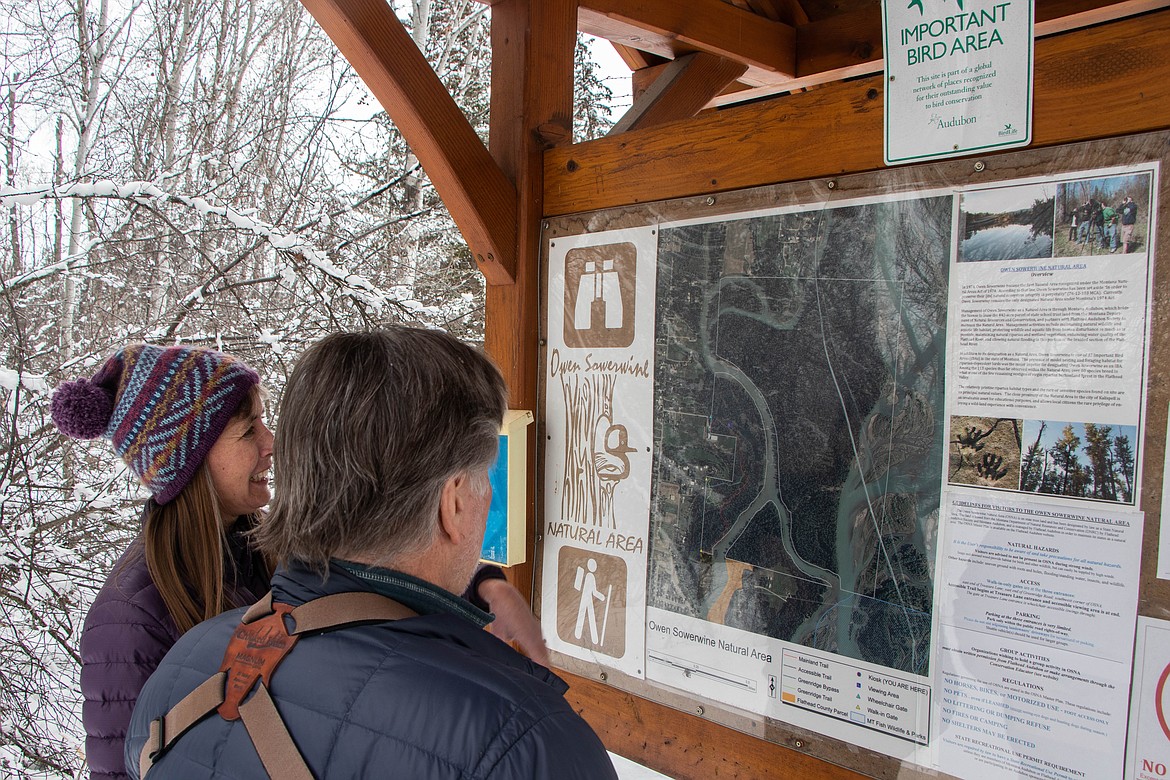 Laura Katzman, with the Flathead Land Trust, and Denny Olson, with Flathead Audubon, look at the Owen Sowerwine map on March 1, 2023. (Kate Heston/Daily Inter Lake)