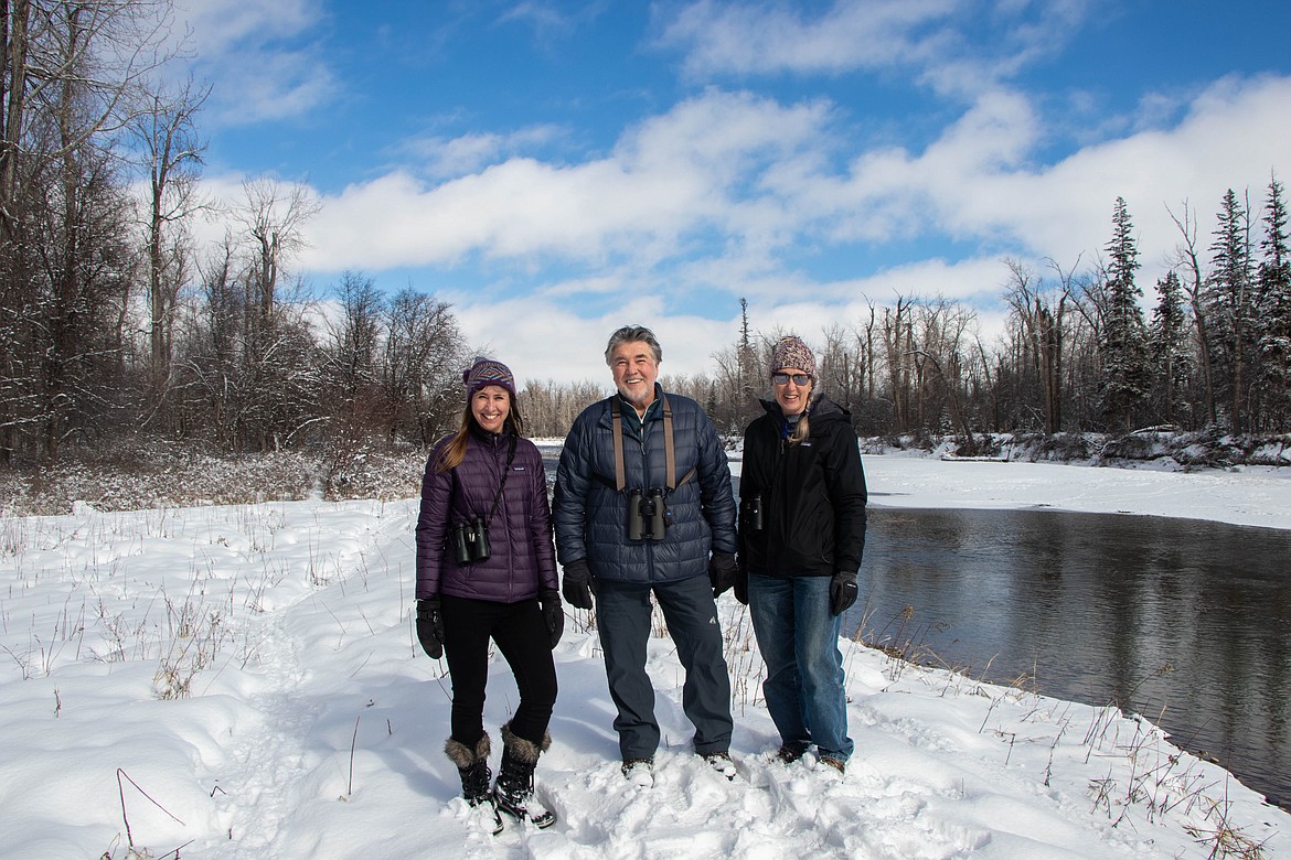 From left to right stand Laura Katzman, a land protection specialist with the Flathead Land Trust; Denny Olson, the Flathead Audubon Conservation Director; and Pam Willison, the Owen Sowerwine Committee Char, for a portrait near the Stillwater River in Owen Sowerwine on March 1, 2023. (Kate Heston/Daily Inter Lake)