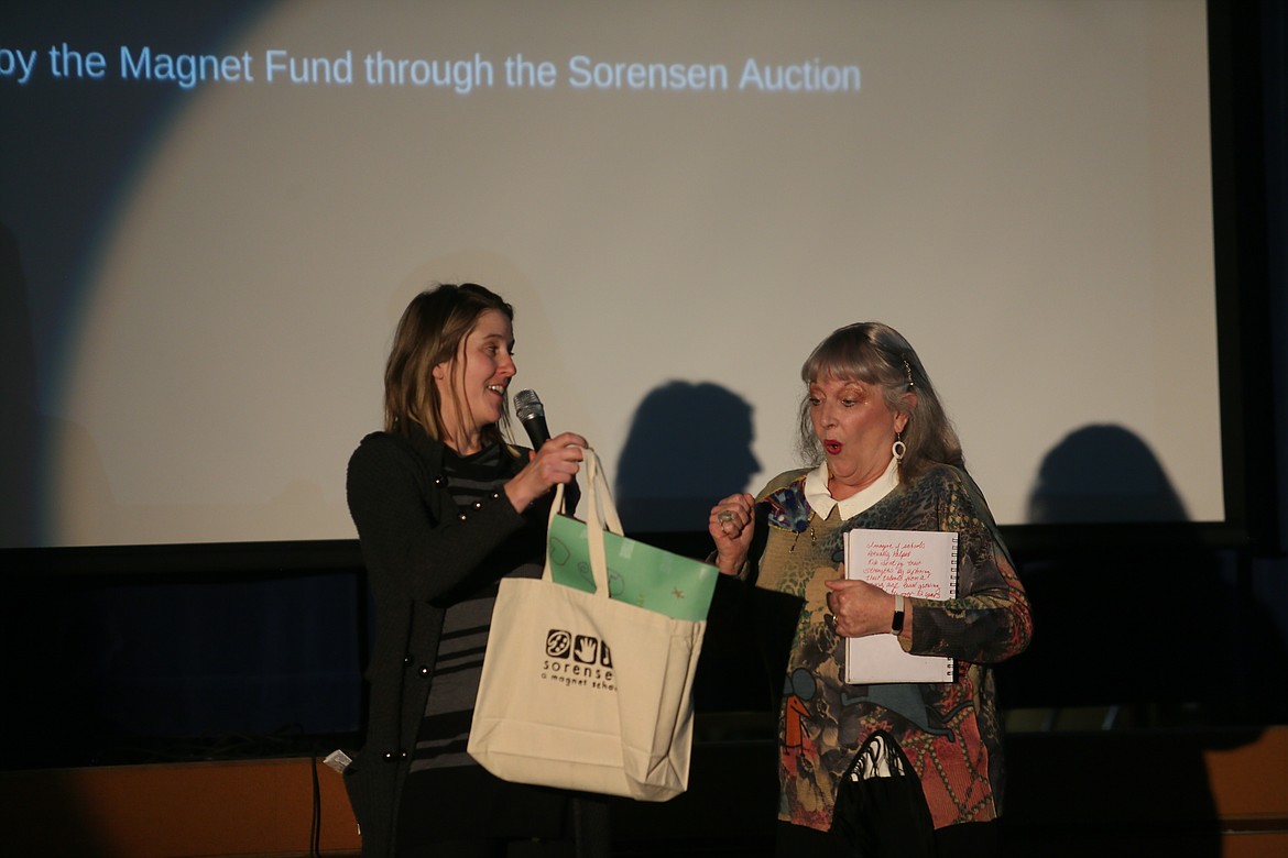 Jill McFarlane, art director for Sorensen Magnet School of the Arts and Humanities, presents visual artist Diane Garmire with a bag of goodies and "thank you" notes Friday as the school celebrates the culmination of her time as its most recent artist-in-residence.