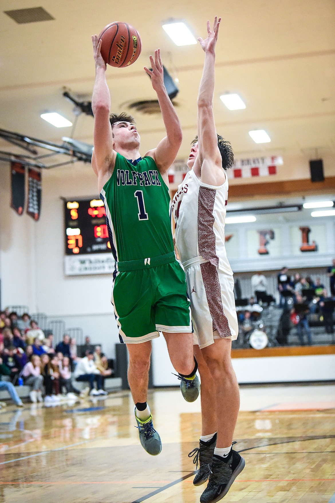 Glacier's Cohen Kastelitz (1) goes to the basket against Helena's Cael Murgel (24) in the second half of the Western AA Divisional Tournament semifinal at Flathead High School on Friday, March 3. (Casey Kreider/Daily Inter Lake)