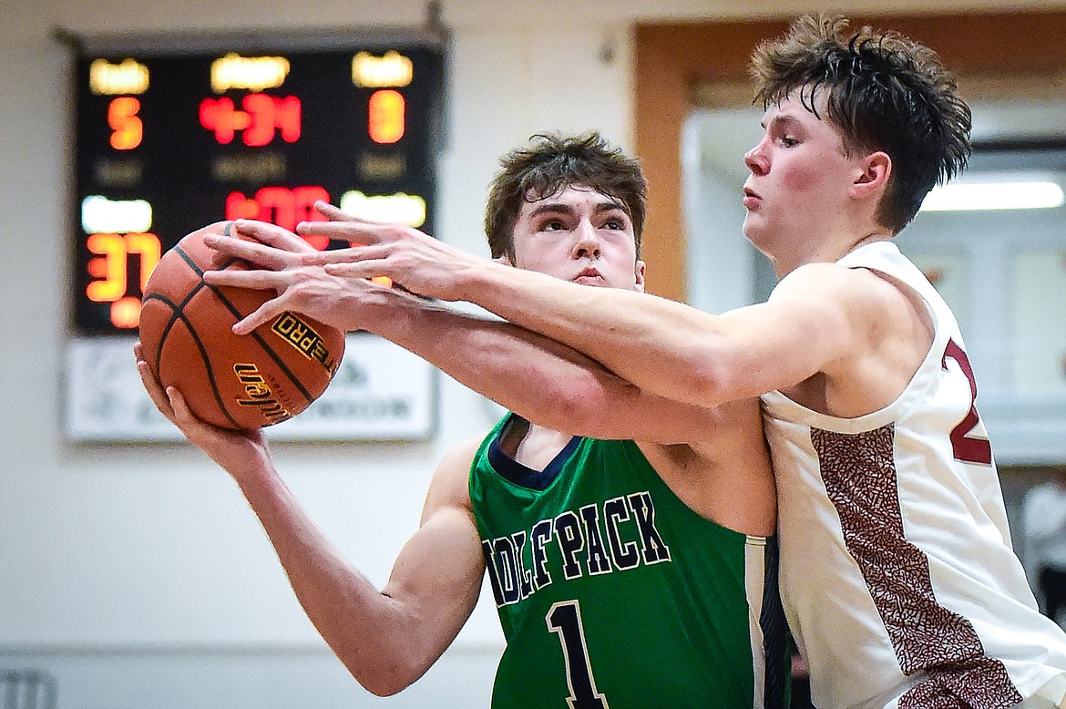 Glacier's Cohen Kastelitz (1) is fouled on his way to the basket by Helena's Cael Murgel (24) in the second half of the Western AA Divisional Tournament semifinal at Flathead High School on Friday, March 3. (Casey Kreider/Daily Inter Lake)