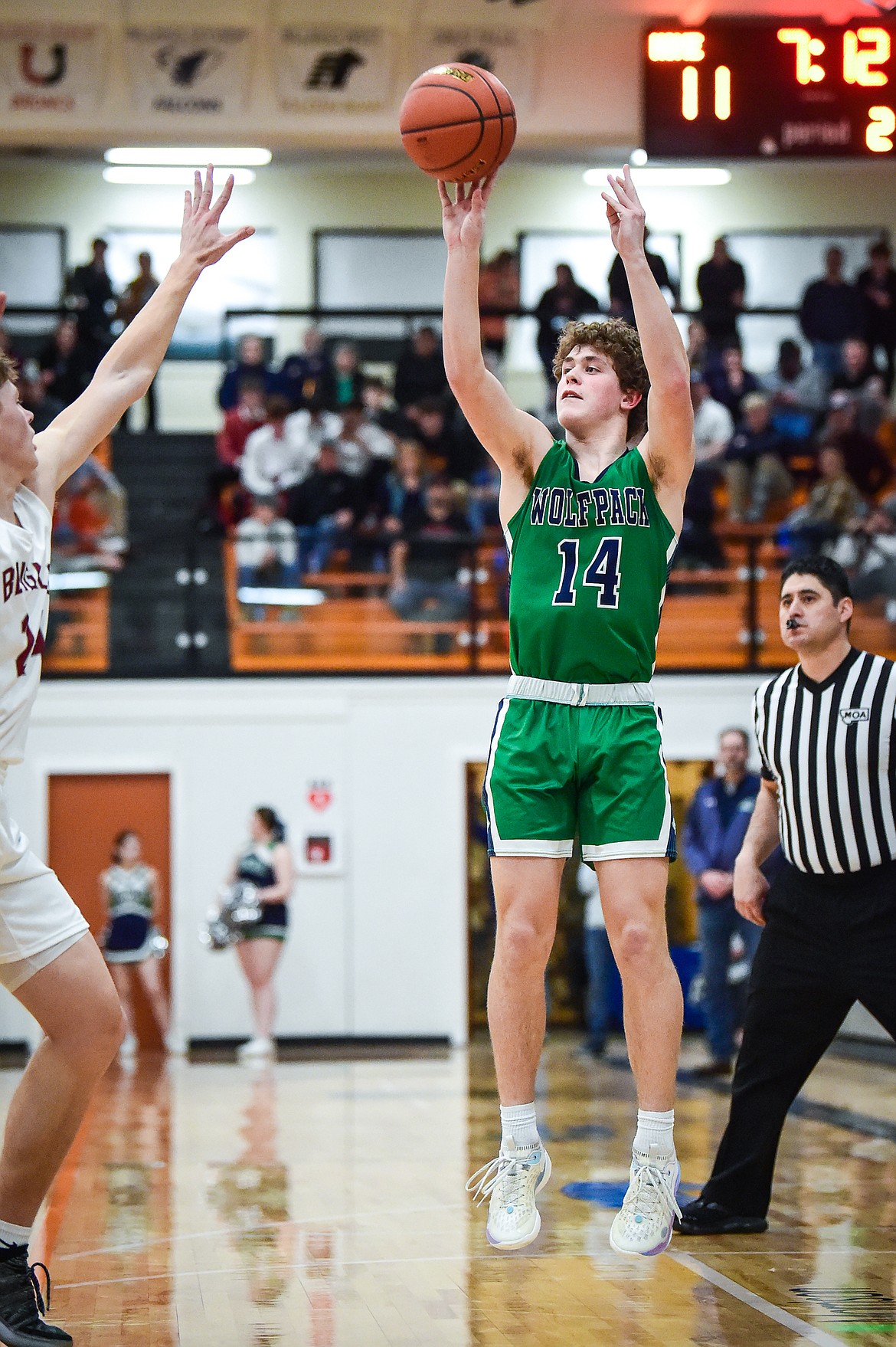 Glacier's Kaidrian Buls (14) knocks down a three in the first half against Helena in the Western AA Divisional Tournament semifinal at Flathead High School on Friday, March 3. (Casey Kreider/Daily Inter Lake)