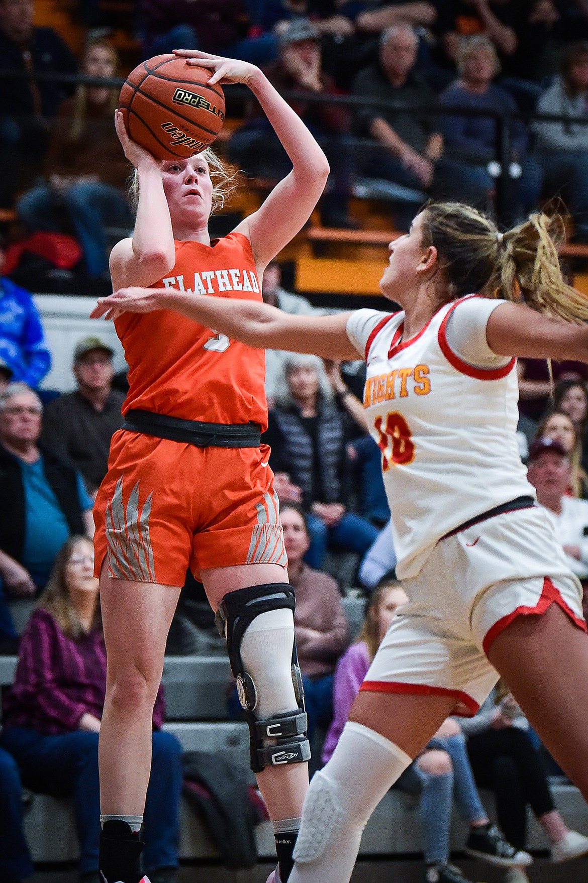 Flathead's Maddy Moy (5) sinks a three in the second half against Missoula Hellgate's Chloe Larsen (10) in the the Western AA Divisional Championship at Flathead High School on Saturday, March 4. (Casey Kreider/Daily Inter Lake)