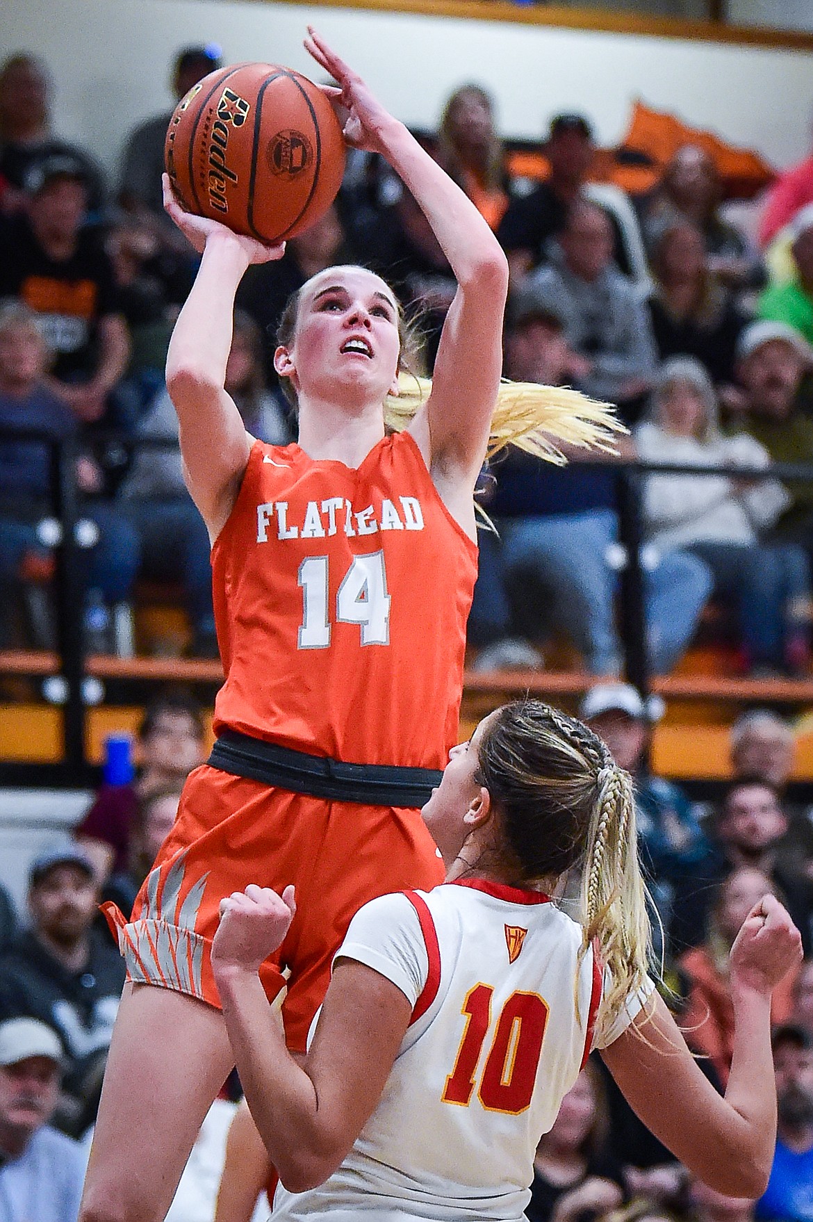 Flathead's Kennedy Moore (14) shoots in the second half against Missoula Hellgate's Chloe Larsen (10) in the the Western AA Divisional Championship at Flathead High School on Saturday, March 4. (Casey Kreider/Daily Inter Lake)