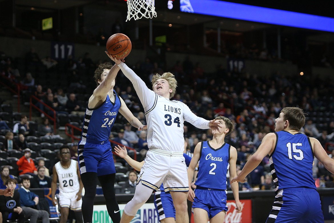 With his arm outstretched, MLCA/CCS junior Jonah Robertson drives to attempt a layup against Orcas Island on Saturday in the 1B boys consolation semifinals.