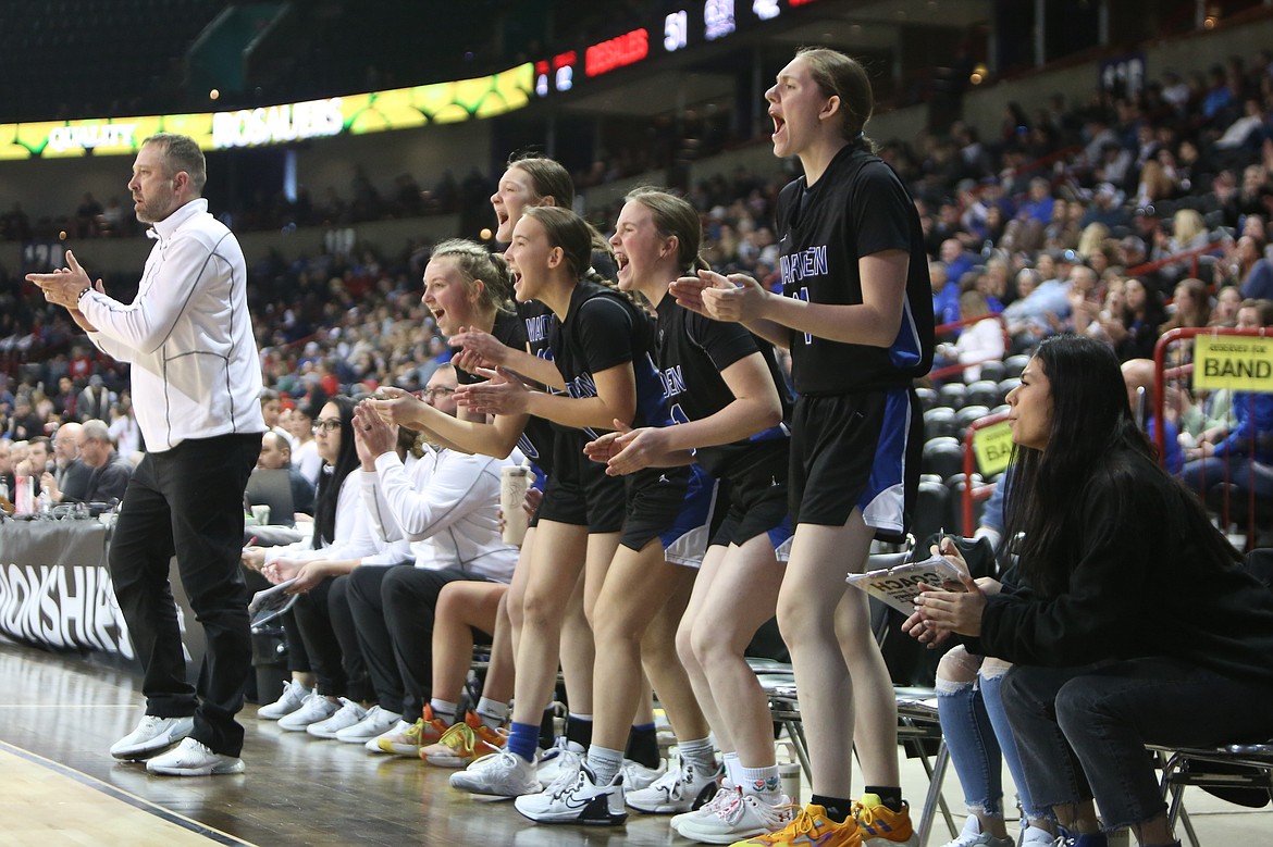 Players on the Warden bench cheer after a made layup by junior Molly Sackmann.