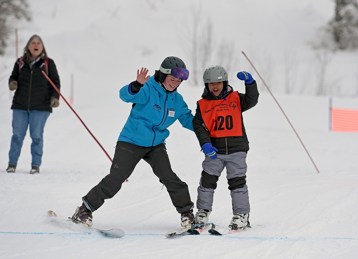 An alpine skiing competitor assisted by a DREAM Adaptive volunteer rides through the course at the Special Olympics Montana Winter Games at Whitefish Mountain Resort on Wednesday, March 1. (Whitney England/Whitefish Pilot)
