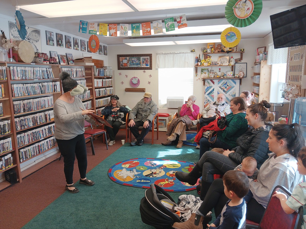 "Horton Hears A Who" is read by Linda Zimmer last Thursday at the Mineral County Library in part of the birthday celebration of Dr. Suess. She admitted that her reading glasses inside the mask were a bit snug once she finished. (Monte Turner/Mineral Independent)