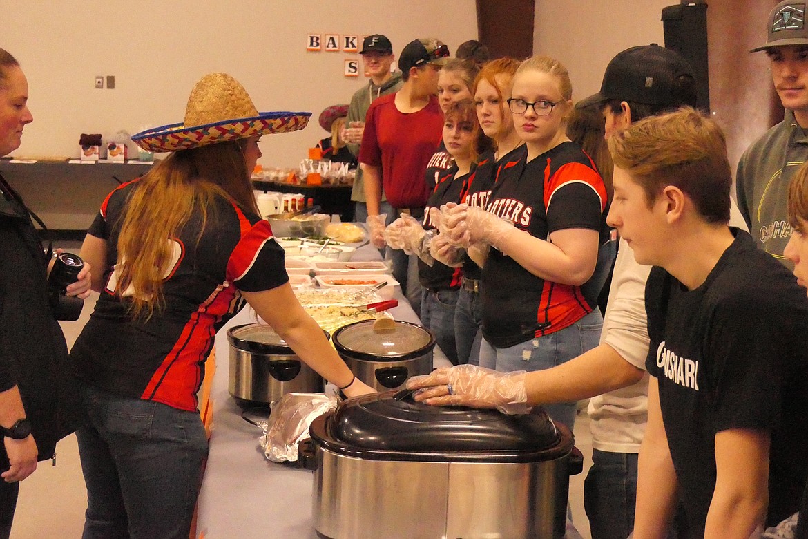 Students serve a Mexican-style dinner that was part of Saturday night's extra-curricular activities fundraiser at Plains High School. (Chuck Bandel/VP-MI)