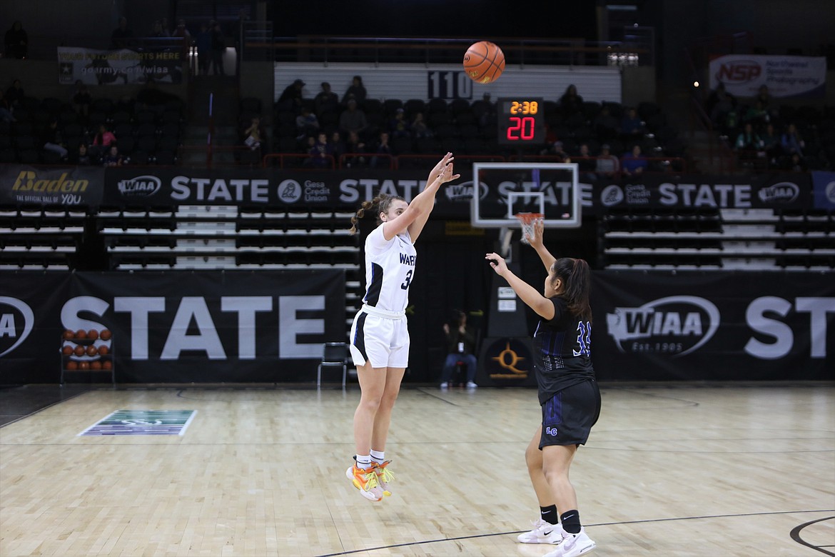 Warden senior Quinn Erdmann, in white, shoots a three-pointer in the second half against La Conner in the 2B state quarterfinals in the Spokane Arena on Thursday.