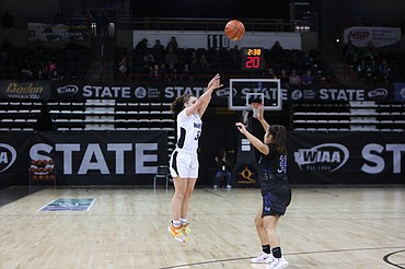 Warden senior Quinn Erdmann, in white, shoots a three-pointer in the second half against La Conner in the 2B state quarterfinals in the Spokane Arena on Thursday.