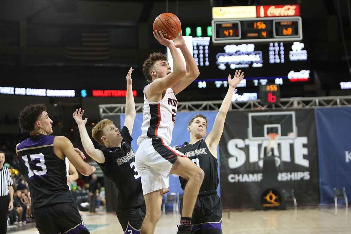 With three defenders on him, Lind-Ritzville/Sprague senior Chase Galbreath attempts a jump shot late in the fourth quarter against Columbia (Burbank) in the 2B boys third/fifth-place match.
