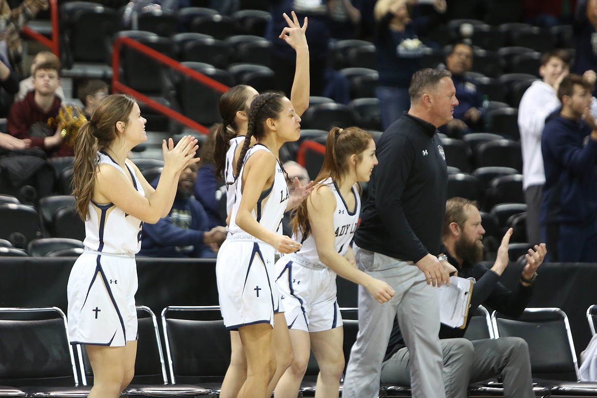 Players on the bench during the MLCA/CCS girls game against Odessa celebrate after a three-pointer.