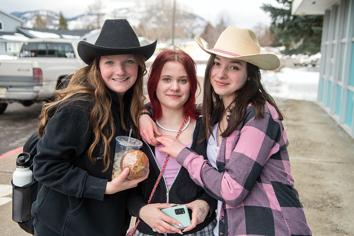 From left, Molly Bagley, Zoe Van and Casey Longstreth pose for a photo during Bleed Blue Week at Columbia Falls High School. It was cowboys and rock stars day. (Chris Peterson photo)