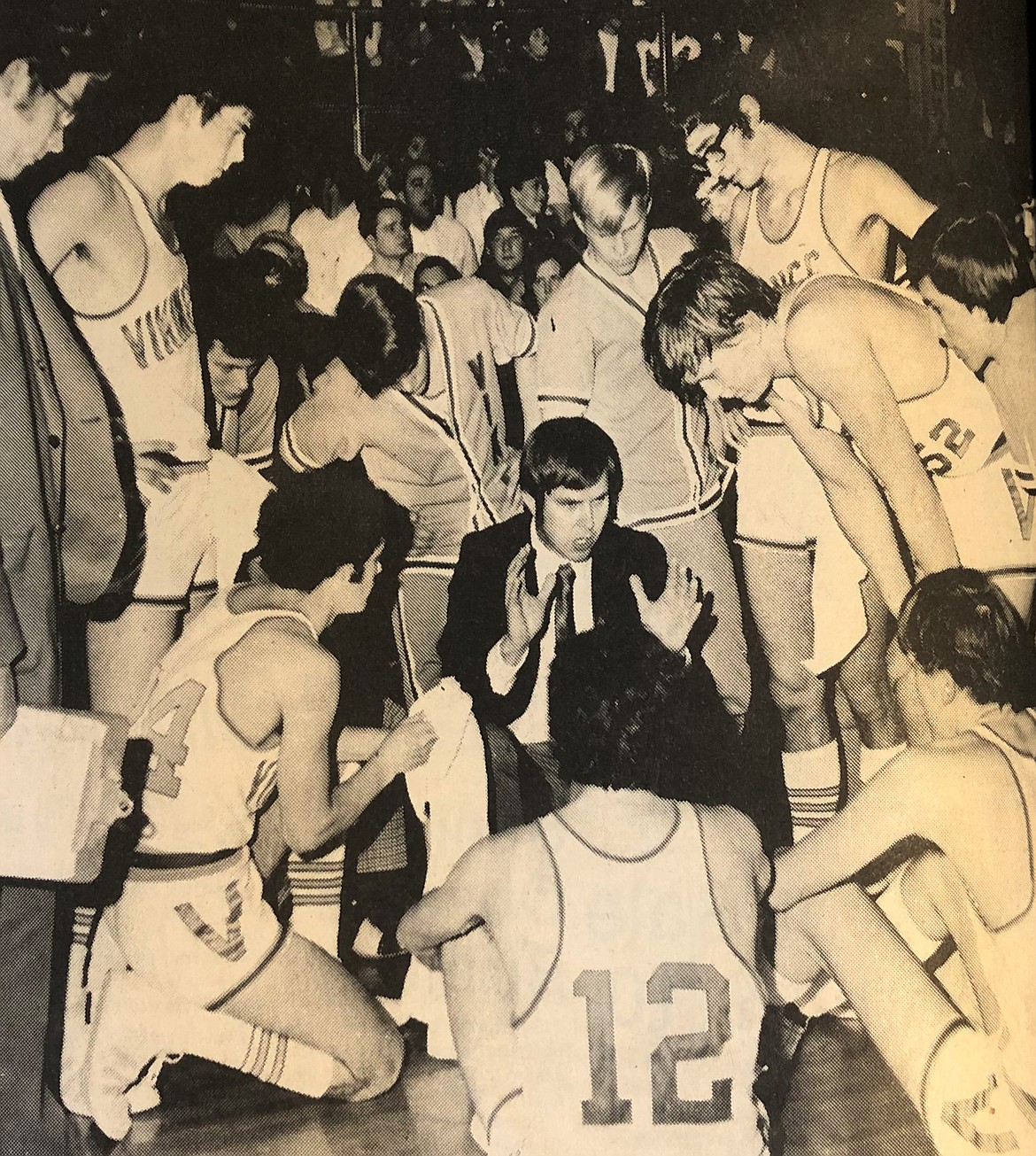 Coach Dean Lundblad strategizes with 1973 state champion Viks.