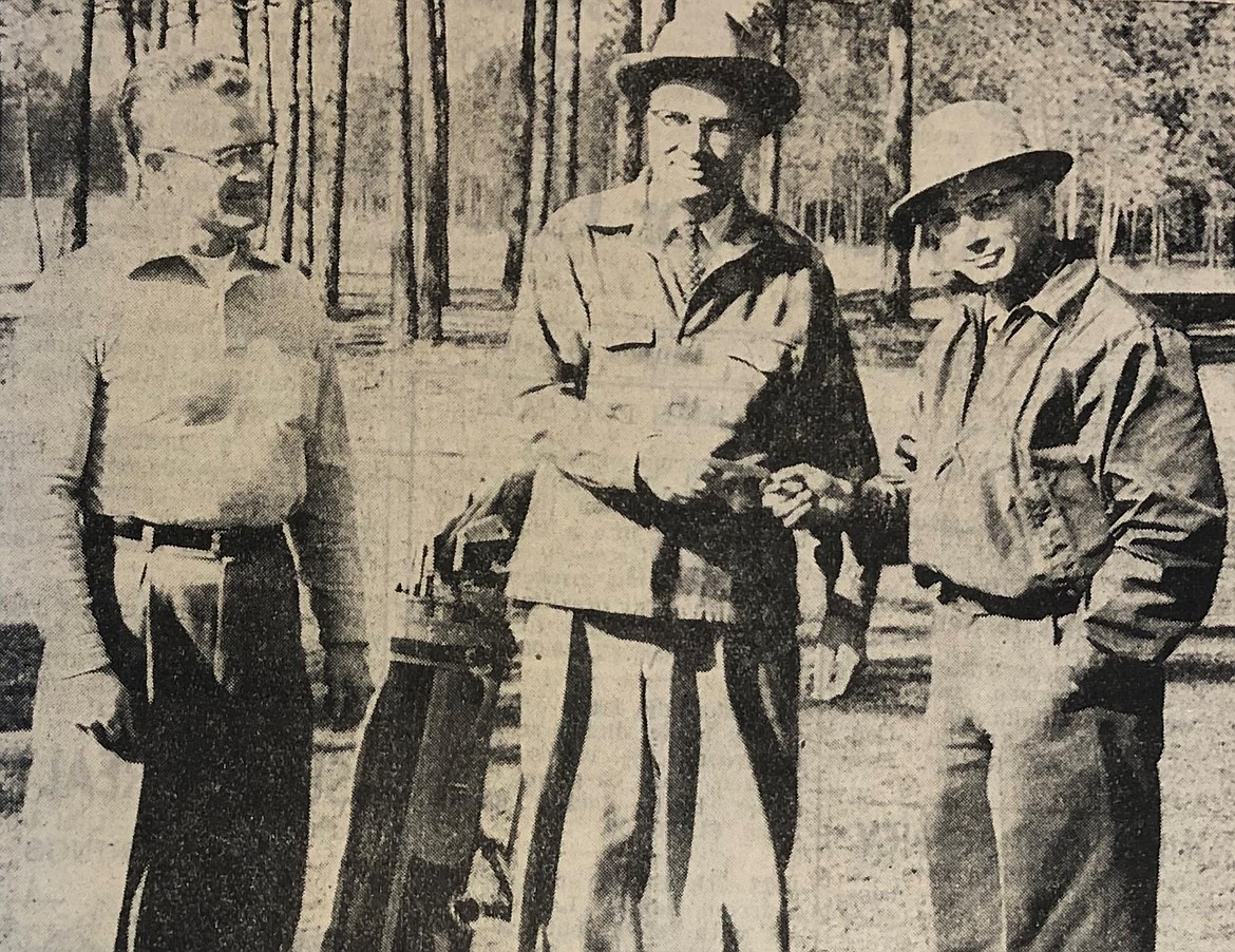 In 1958, Mayor Perry Christianson, center, buys a Coeur d'Alene Public Golf Course membership from Roy Stark, left, and Elmer Parrott.